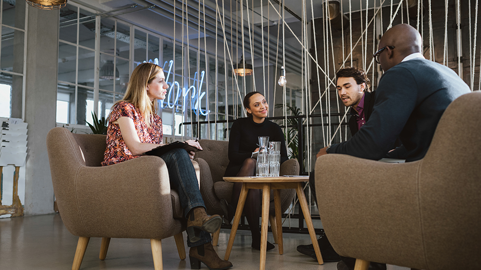 Founders sitting around a table in discussion.