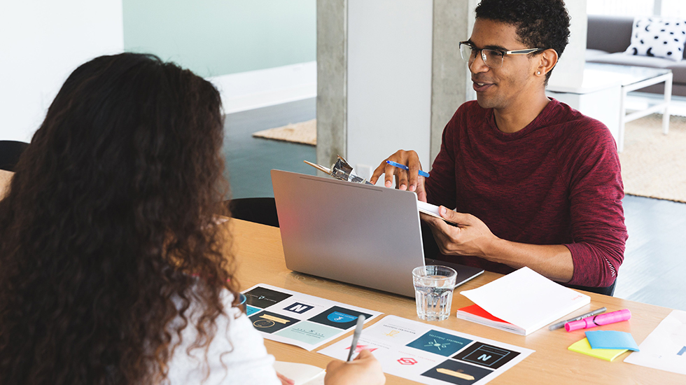 Young tech worker talking at meeting