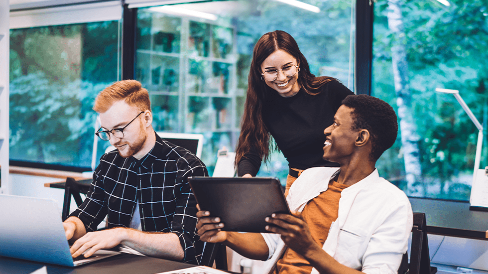 Cheerful diverse employees working on a project